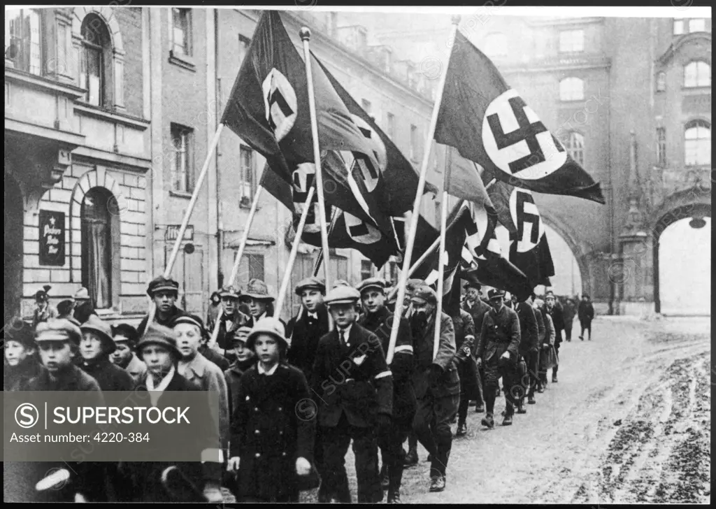 School children marching with  Nazi flags in Munich.         Date: early 1920s