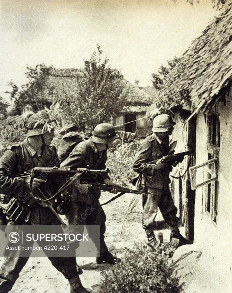 Three German soldiers search a  Russian peasant home : it's  easy while summer lasts, but  soon it will be winter and not  so agreeable      Date: September 1941