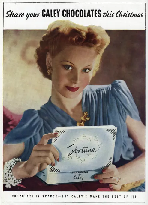 'Chocolate is scarce -but Caley's make the best of it!  Young woman holding a box of 'Fortune' chocolates     Date: 1941