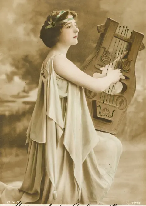 Lady in the costume of a classical Greek harp player     Date: 1903
