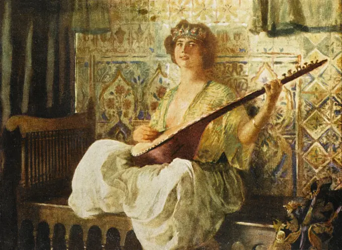 Oriental Fantasy Painting by Ferdinand-Max Bredt depicting a Turkish woman in the Harem playing a long-necked lute, sat crossed-legged on a bench.     Date: circa 1910s