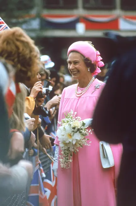 Queen Elizabeth II, a vision in pink smiles and chat with crowds of well wishers as she goes on a royal walkabout in London to celebrate the Silver Jubilee in 1977.  