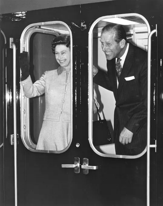 Queen Elizabeth II and the Duke of Edinburgh waving from a train in the year of the Silver Jubilee.       Date: 1977