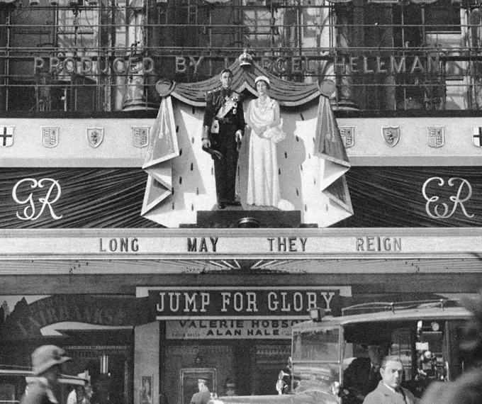 Among the decorations in London inspired by the Coronation of King George VI and Queen Elizabeth were these life-size effigies of the royal couple, the focal point of the elaborate decorations on the facade of the London Pavilion.       Date: 1937