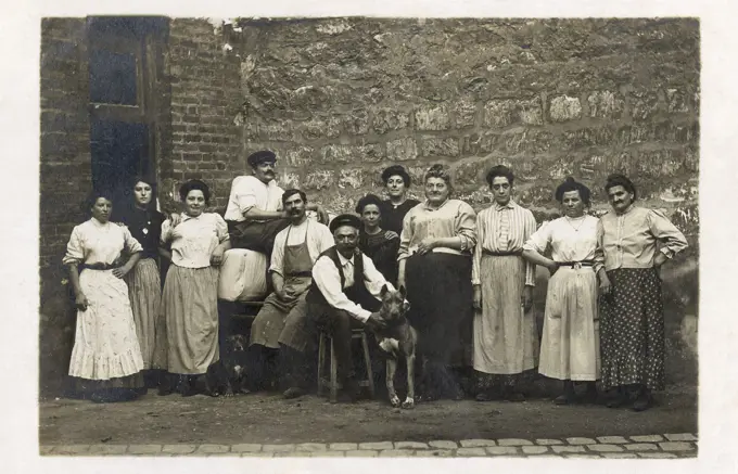 Group of working people with a dog, France.      Date: circa 1920s