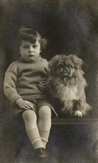 Studio portrait, boy with Pekingese dog, photo by Medway Studios, Gillingham, Kent.      Date: circa 1920s
