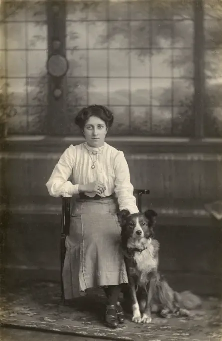 Studio portrait, young woman with dog, photo by J J Payne of Hull, Grimsby and Barnsley.      Date: circa 1920s