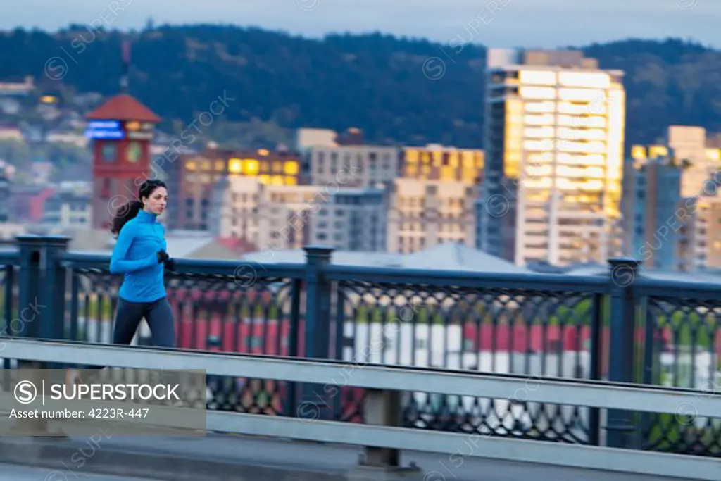 Woman running along bridge