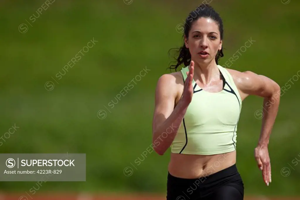 Woman sprinter running, close-up