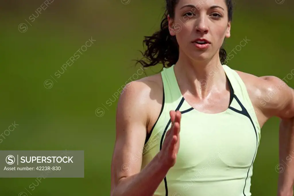 Woman sprinter running, close-up