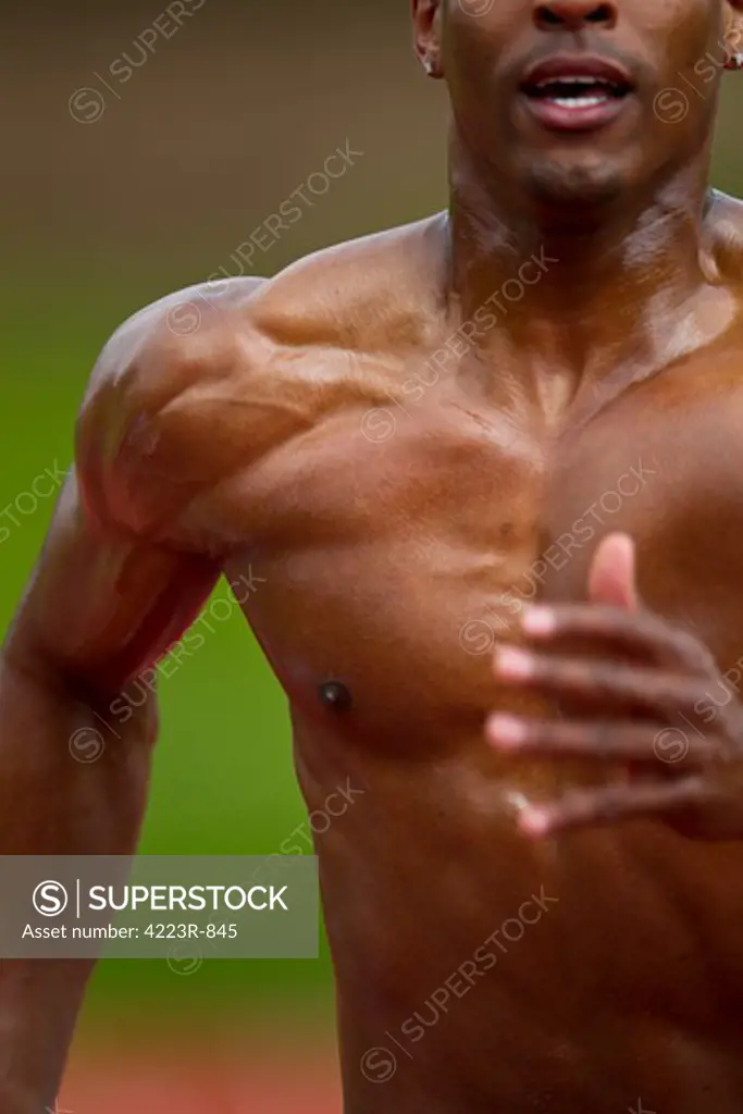 Man sprinting down track, close-up