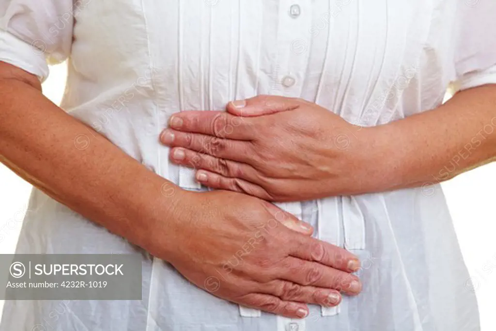 Elderly woman holding her hands to her aching stomach