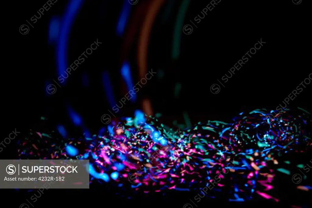 Colorful abstract confetti light in front of black background