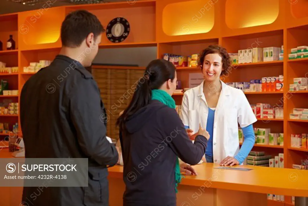 Two customers Waiting in line in pharmacy for the pharmacist