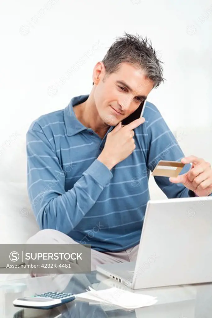 Man shopping online with credit card and cell phone