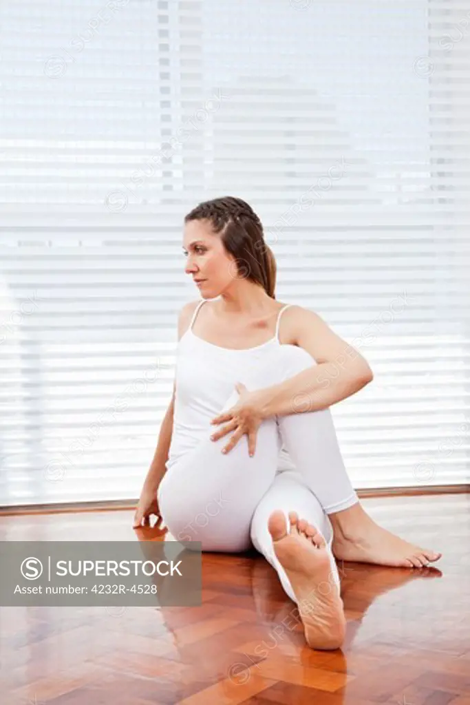 Elderly woman at home stretching before fitness training