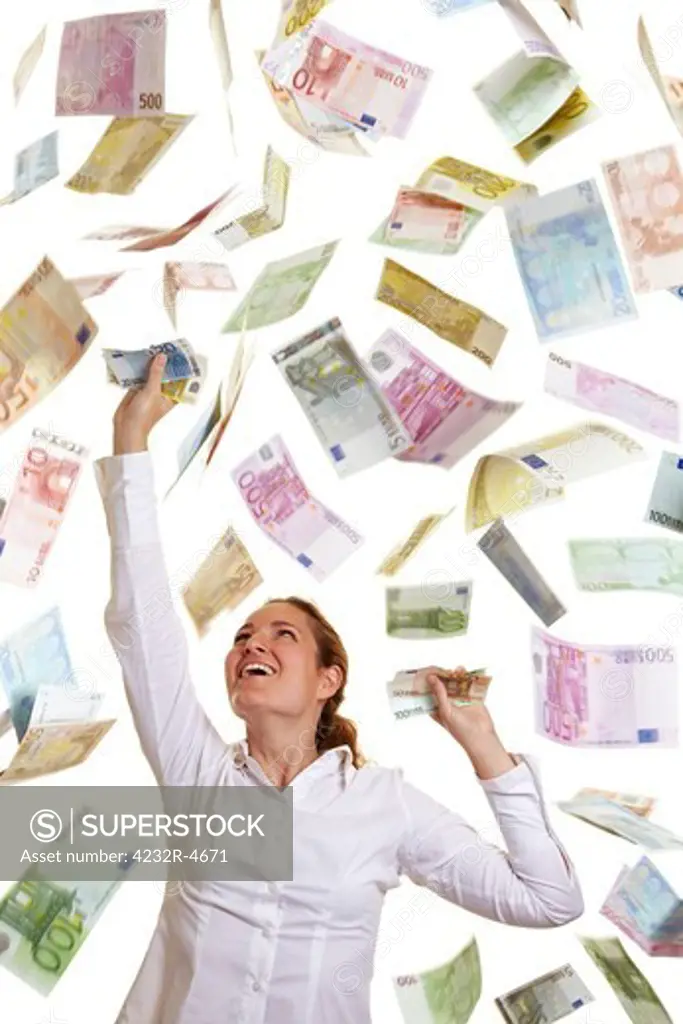 Happy business woman catching falling Euro money