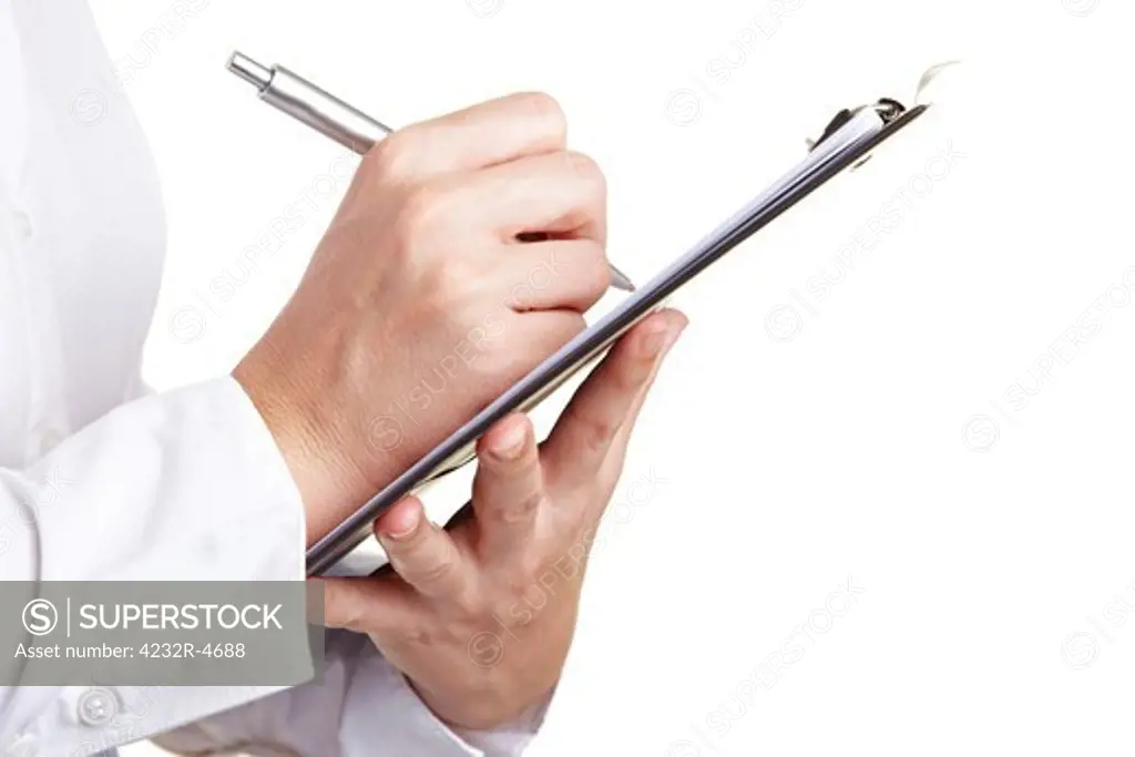 Hand filling out checklist on clipboard with a pen