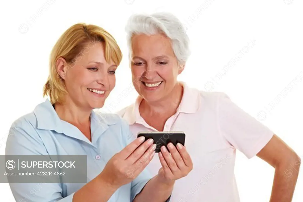 Happy senior woman looking at a smartphone
