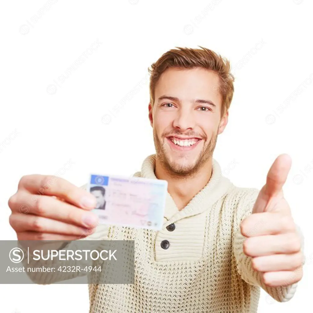 Happy man with his European drivers licence holding his thumbs up