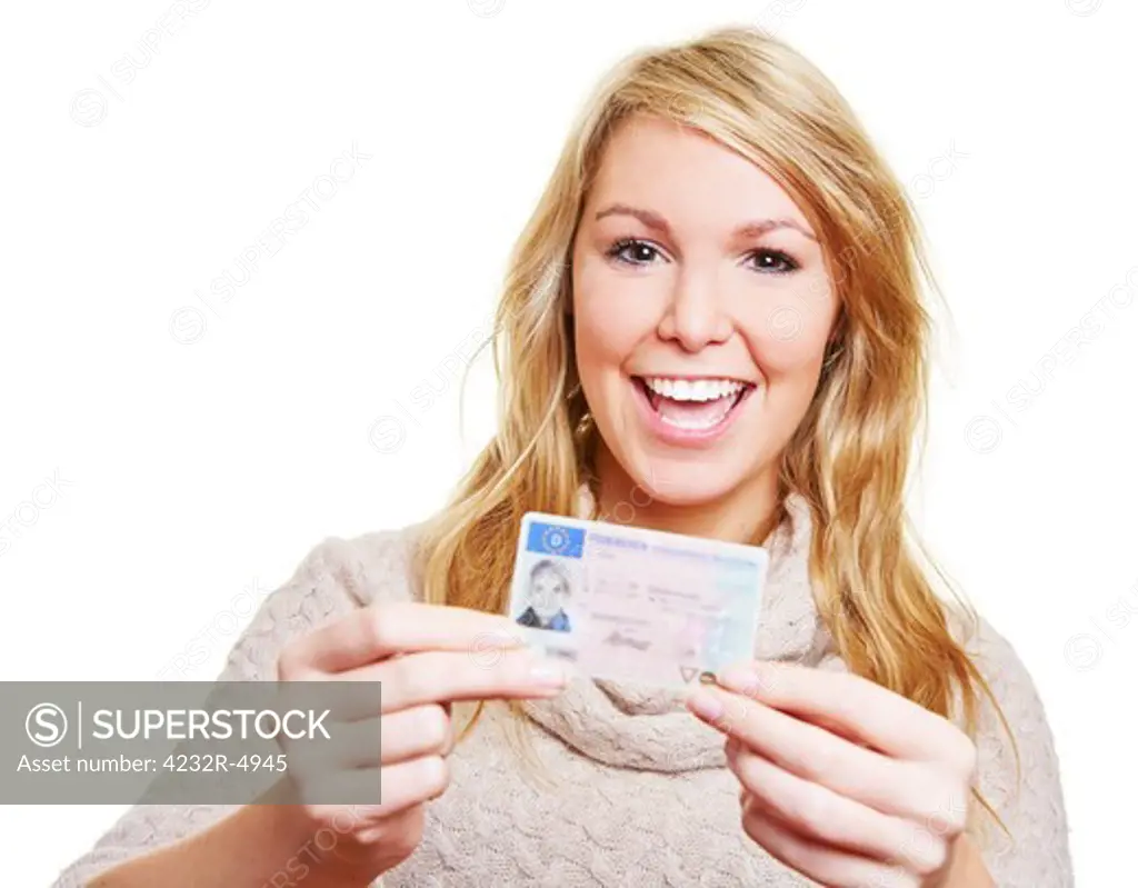 Happy young woman showing proudly her new driving licence