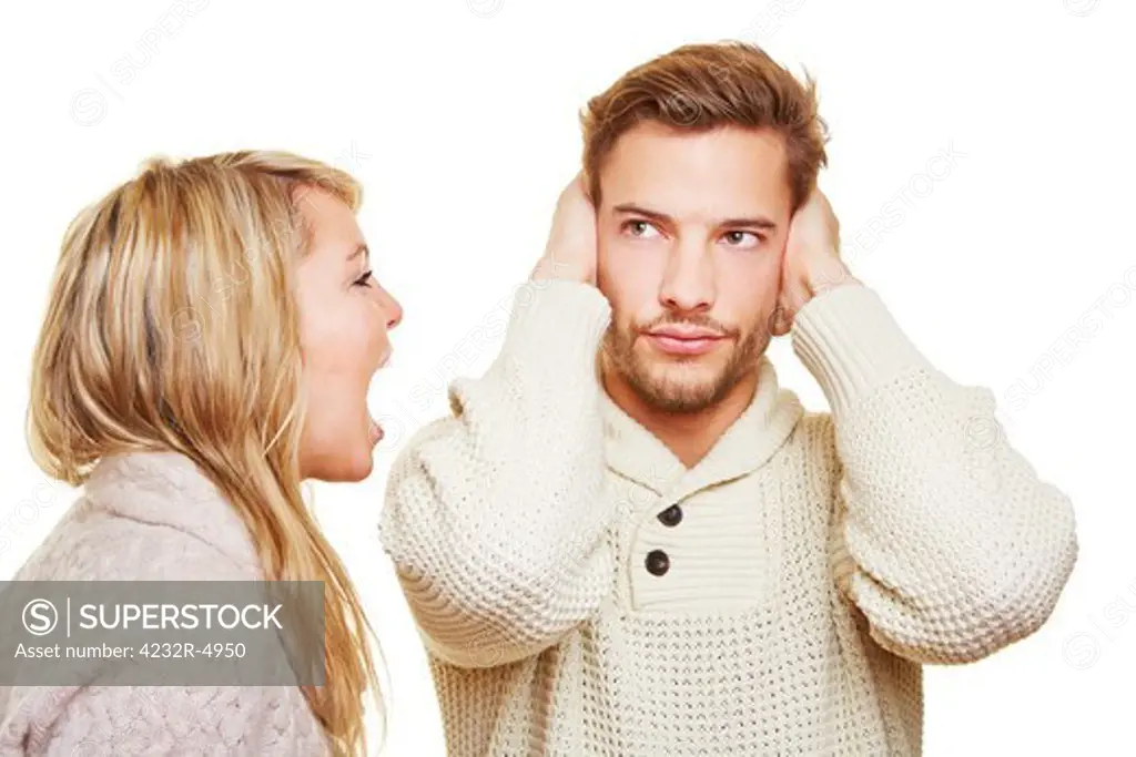 Young angry woman screaming and sulking man closing his ears