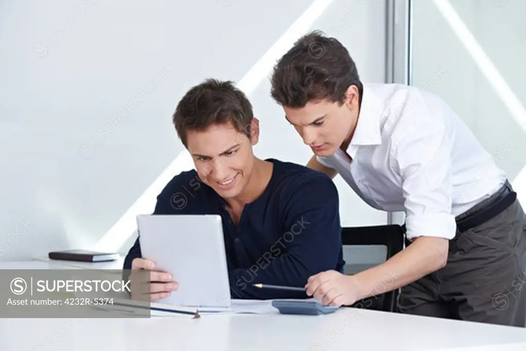 Architects in their office looking at a tablet computer