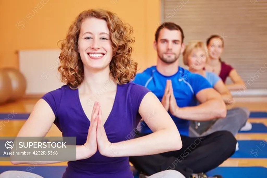 Happy woman smiling in yoga class in a fitness center