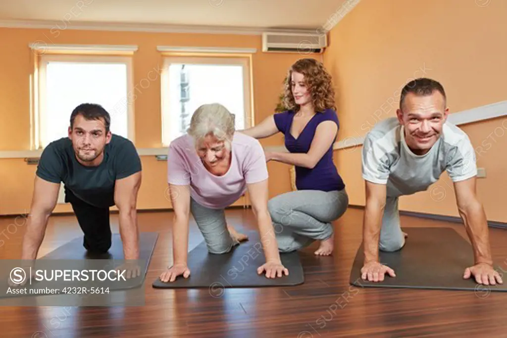 Group doing senior sport with instructor in fitness center