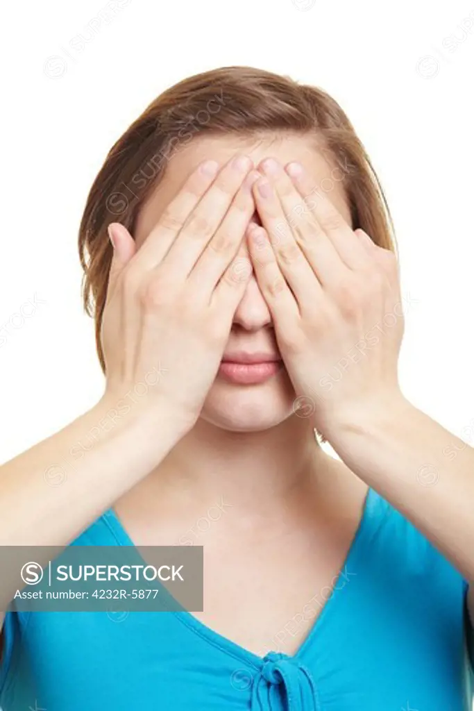 Young woman covering her eyes with both hands