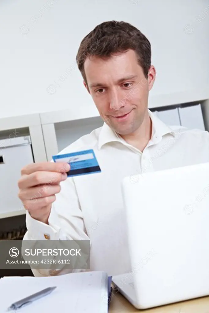 Business man buying online with credit card and laptop