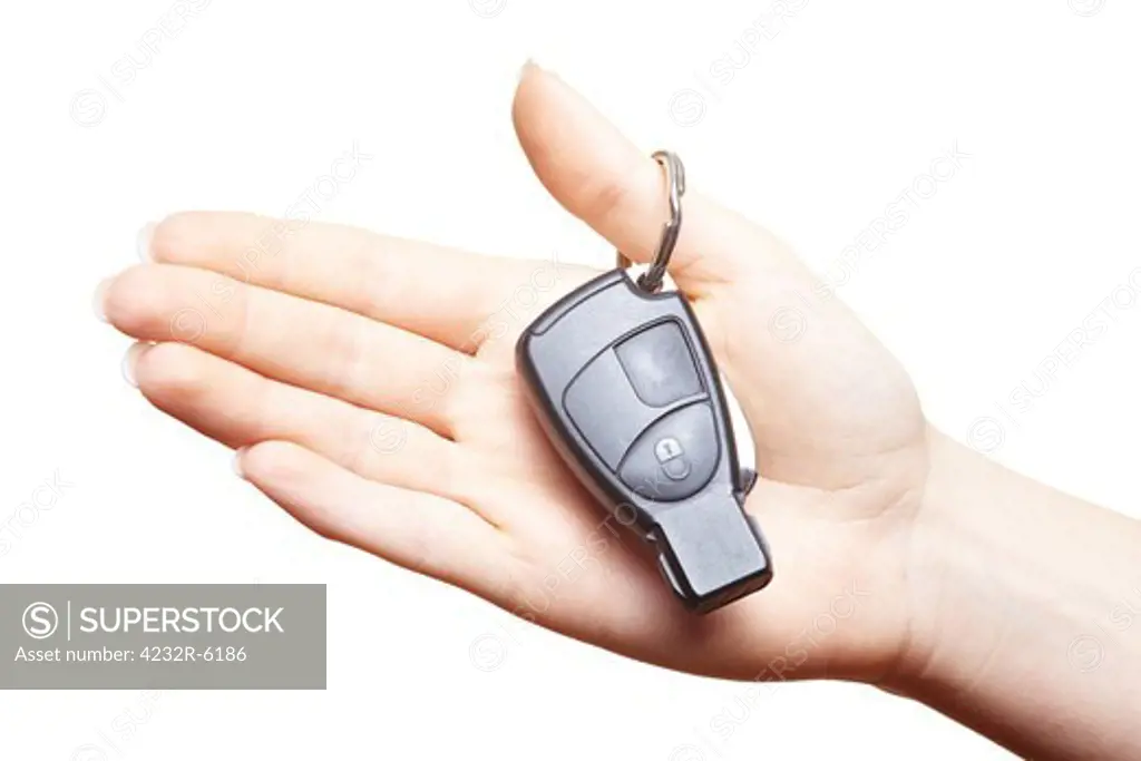 Female hand holding car keys in the palm