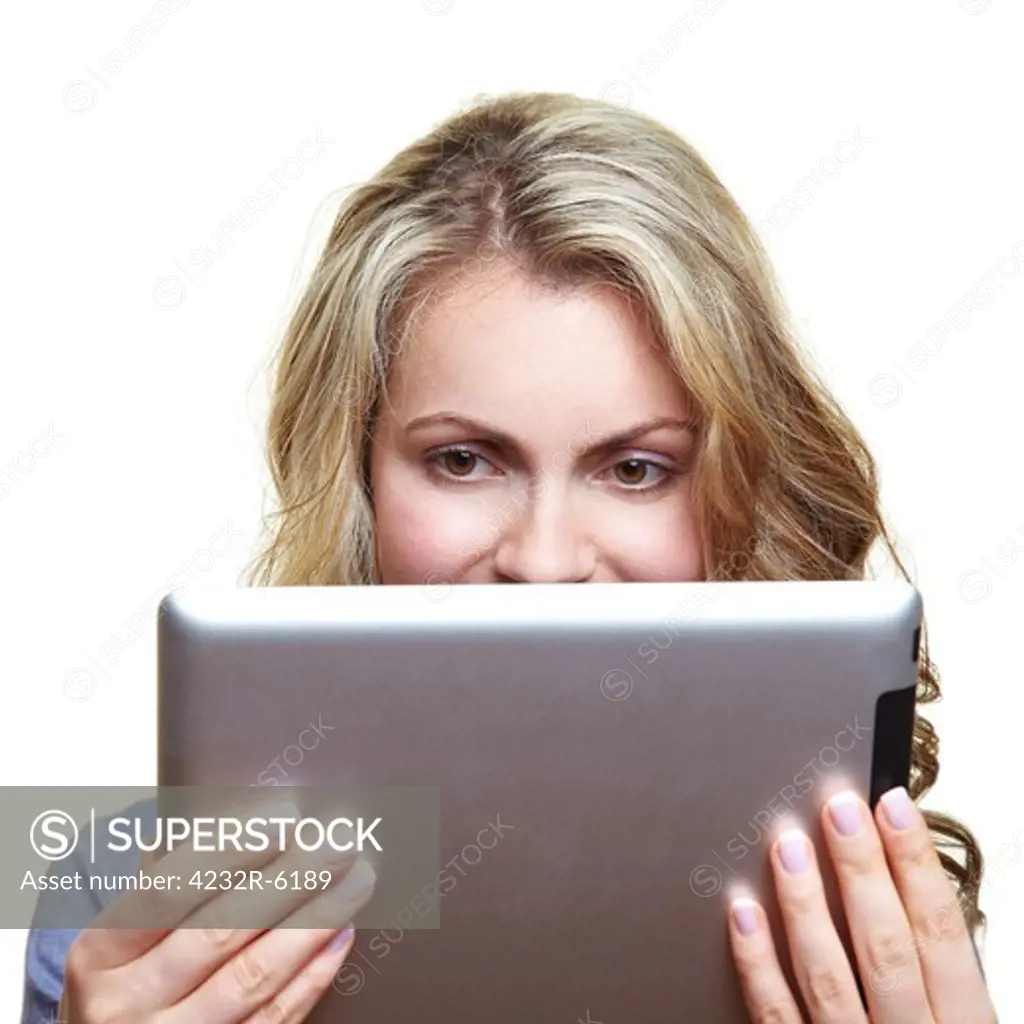 Blonde woman reading a digital book with an ebook reader
