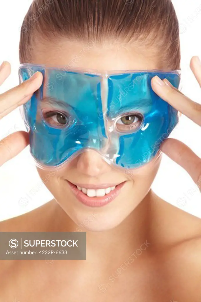 Attractive woman using refreshing gel mask for her eyes