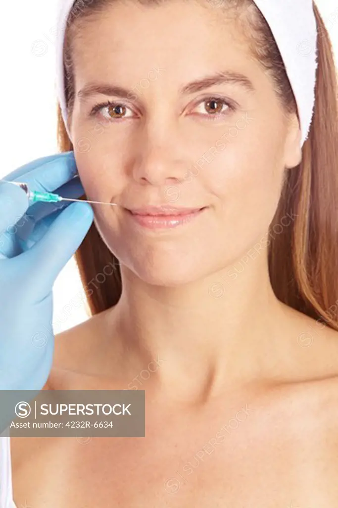 Attractive elderly woman getting plastic surgery with syringe