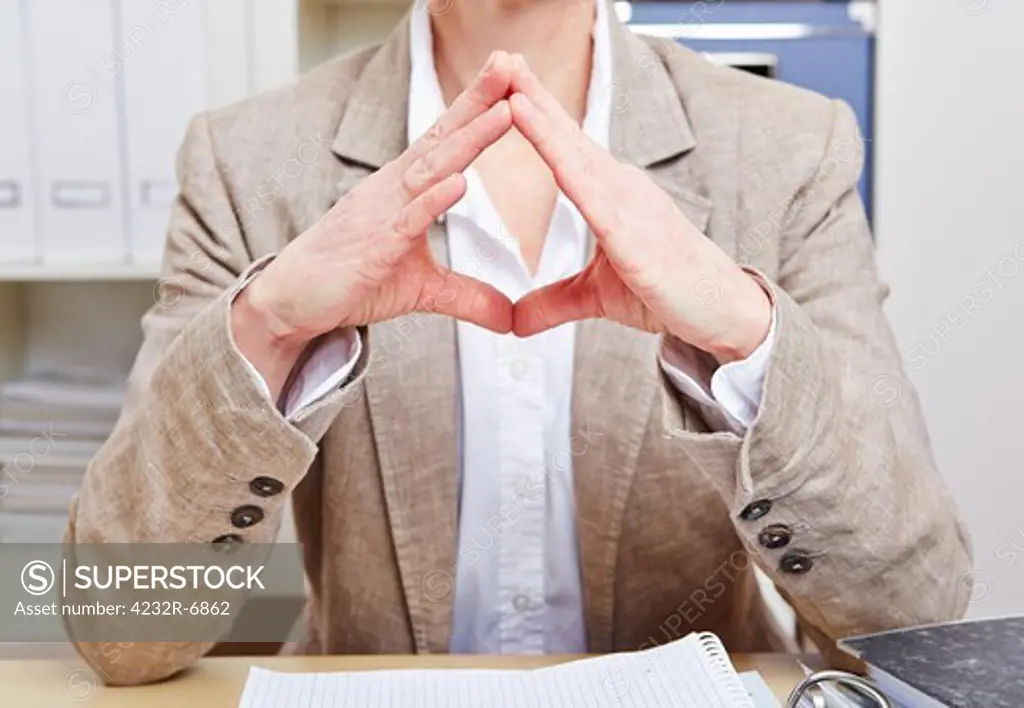 Body language of a senior business woman in her office