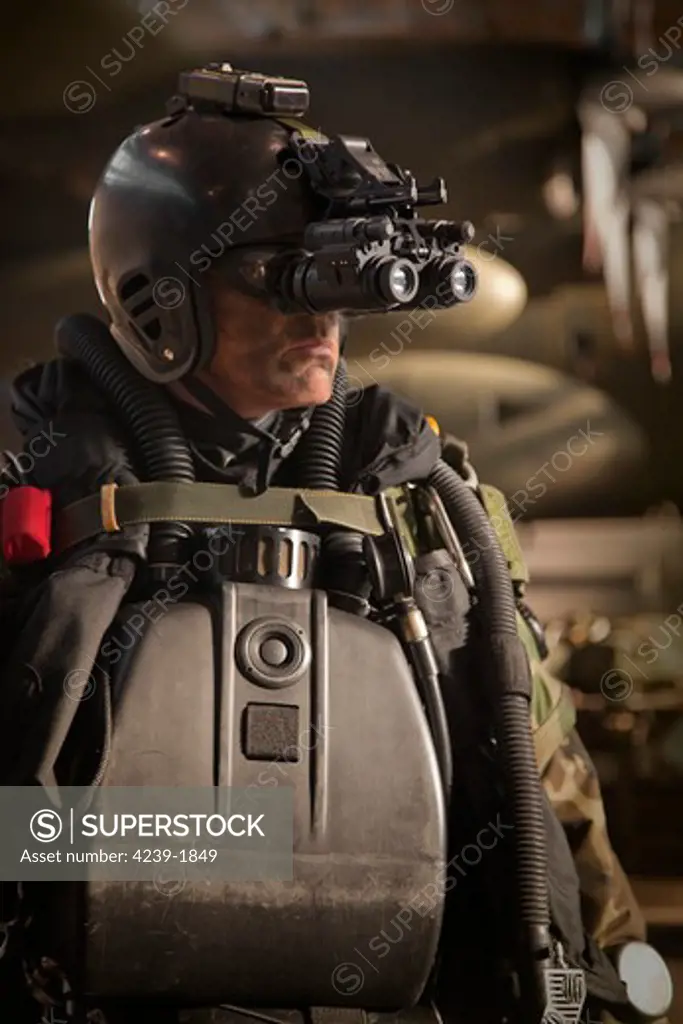 U.S. Navy Seal combat diver equipped with night vision prepares for HALO jump operations from a C-130 Hercules.