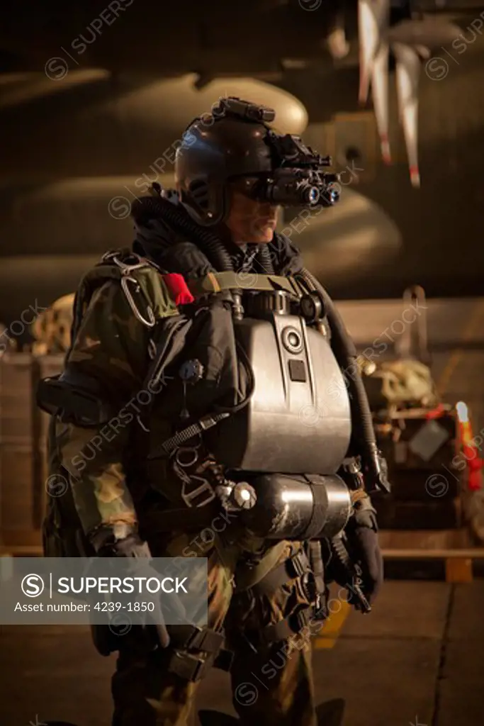 U.S. Navy Seal combat diver equipped with night vision, prepares for HALO jump operations from a C-130 Hercules.