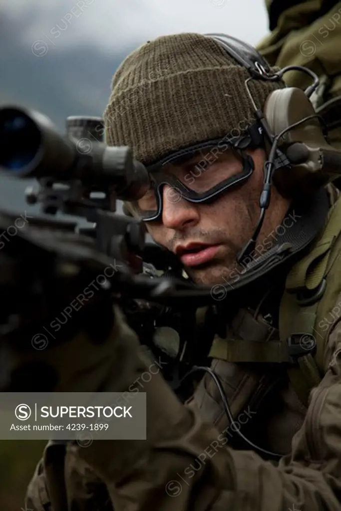 U.S. special forces soldier stays alert while armed with an automatic rifle.