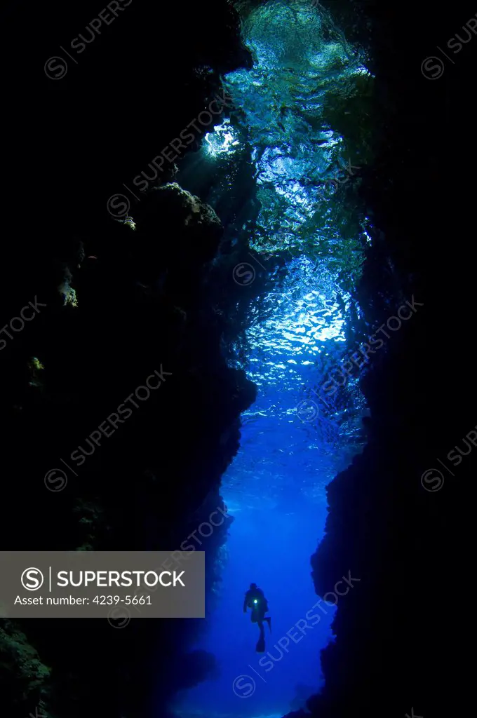 A diver explores the amazing underwater cavern known as Lerus Cut, Russell Islands, Solomons.