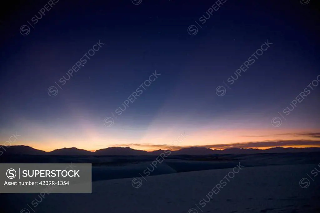 Sunset landscape depicting crepuscular rays at White Sands National Monument, New Mexico