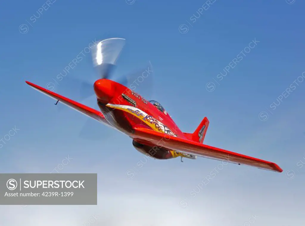 A Dago Red P-51G Mustang modified for competitive air racing, in flight over Hollister, California