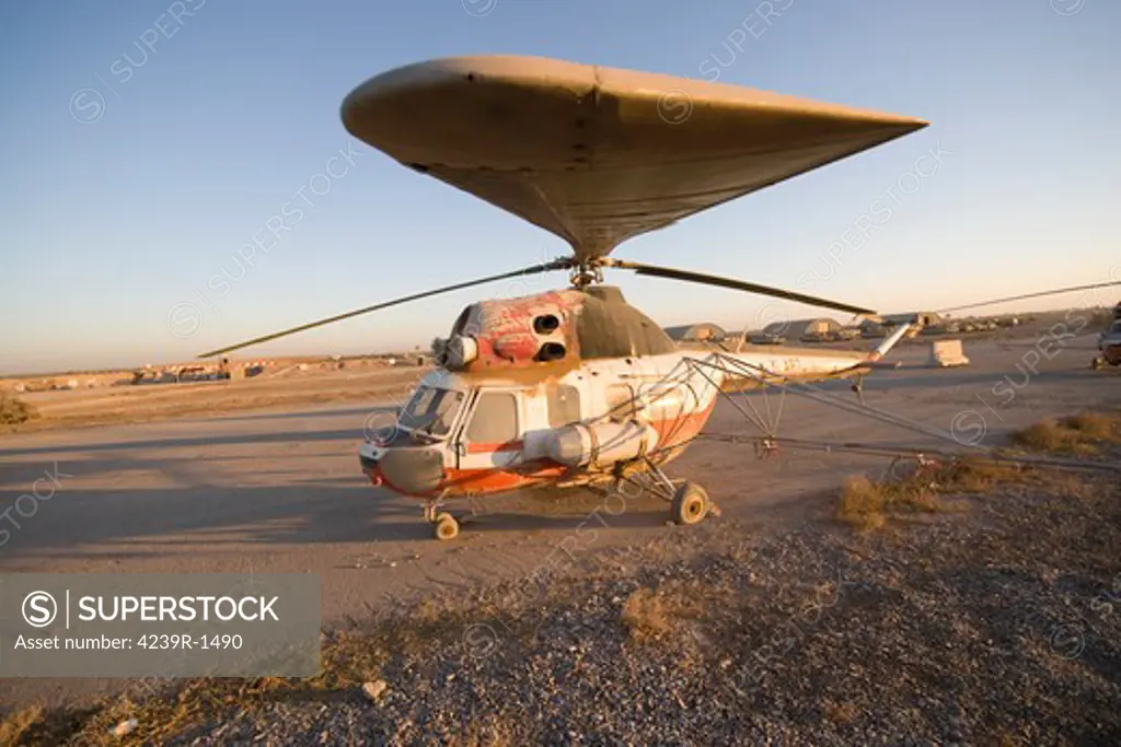 Baqubah, Iraq - An Iraqi Mi-2 helicopter sits on the flight deck abandoned at Camp Warhorse