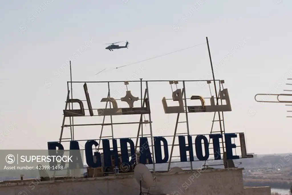 An AH-64 Apache in flight over the Baghdad Hotel in central Baghdad, Iraq