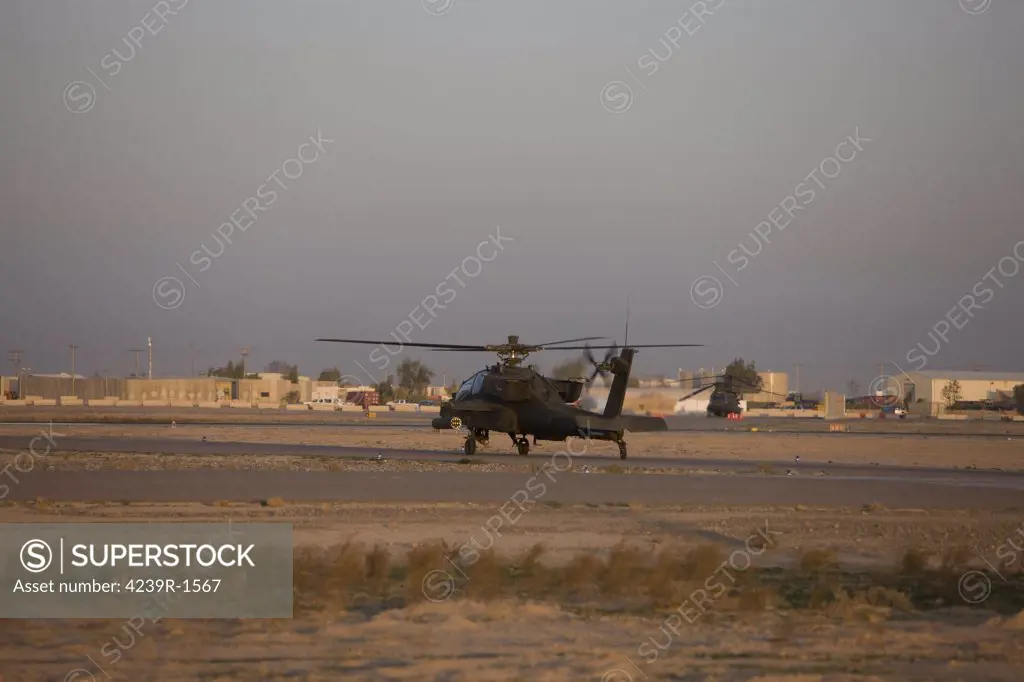 Tikrit, Iraq - An AH-64D Apache Longbow Block III attack helicopter waits for clearance from the flight tower on Camp Speicher