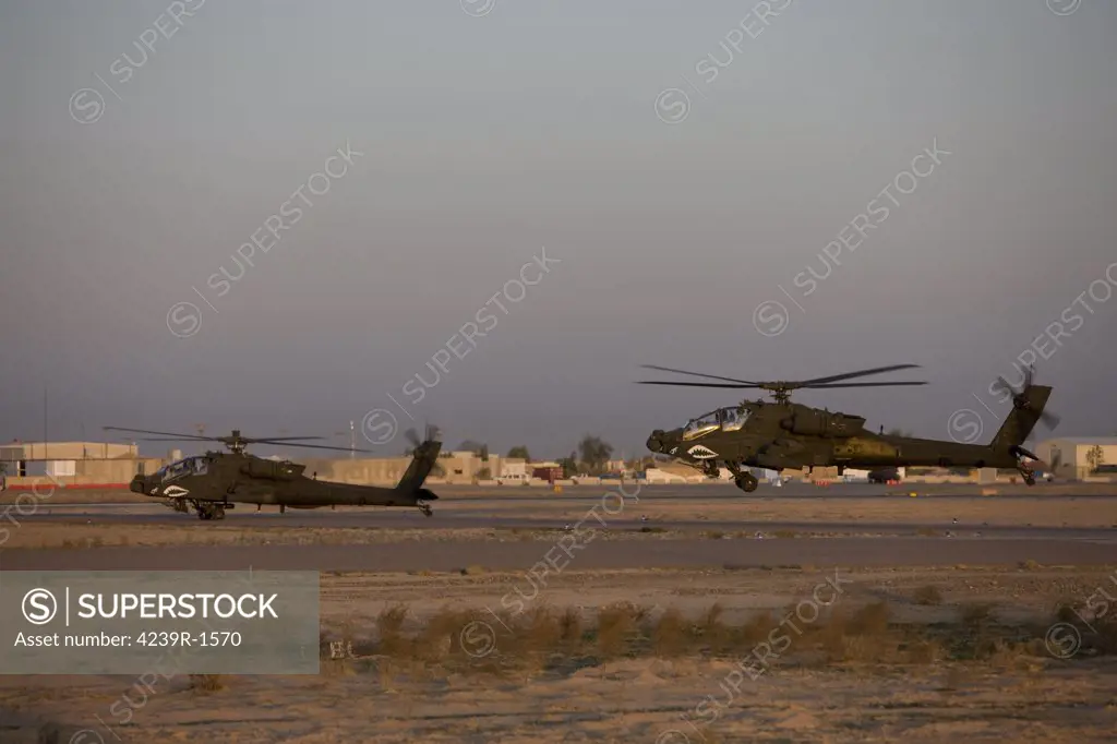 Tikrit, Iraq - A pair of AH-64D Apache Longbow Block III attack helicopters prepare for takeoff