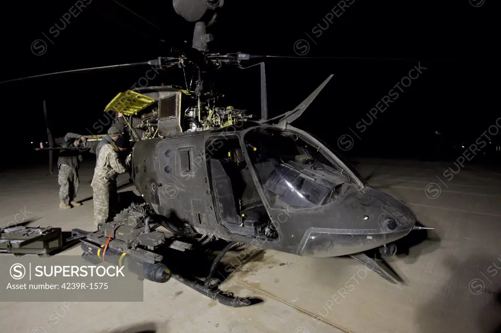 The 6th Squadron, 17th Cavalry Regiment maintenance crew works on servicing the OH-58D Kiowa helicopter before its next mission