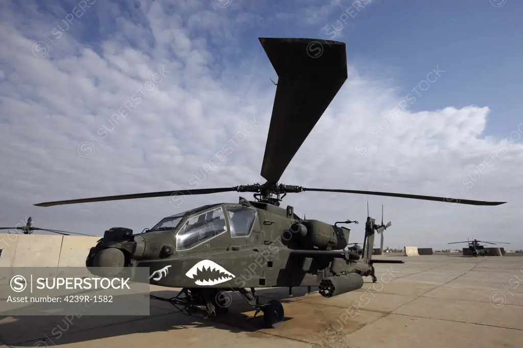 An AH-64D Apache Longbow attack helicopter sits on the flight line at Camp Speicher