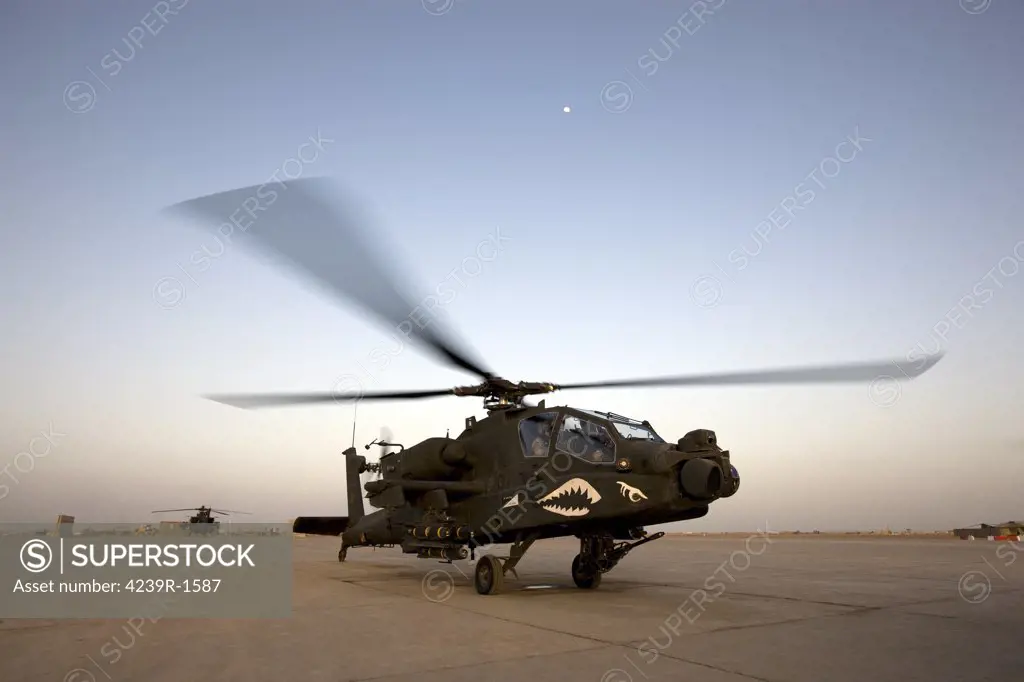 An AH-64D Apache Longbow Block III attack helicopter gets ready for take off at Camp Speicher