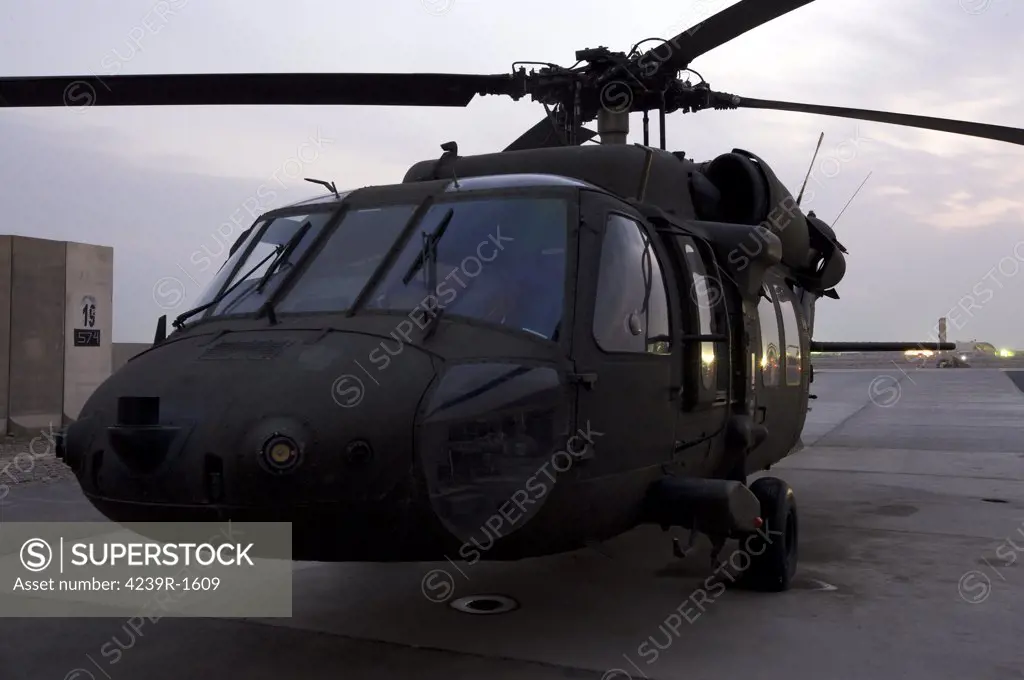 Tikrit, Iraq - A UH-60 Black Hawk helicopter on the flight line at dusk